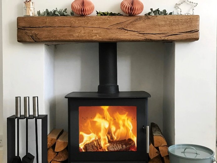 An oak beam above a wood burning stove