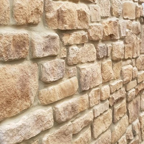 A rustic split stone chamber finish built from irregular natural stone