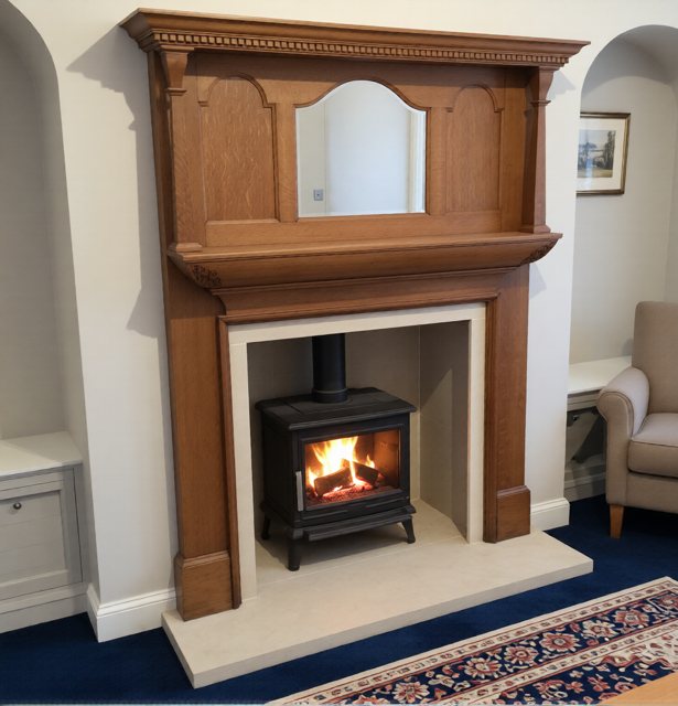 A restored Edwardian oak overmantel surround with an ACR Rowandale stove and Yorkshire sandstone chamber in Selby