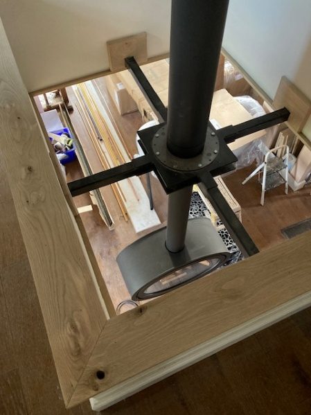 The bespoke curved hearth beneath the stove