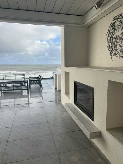 The same fire unlit, showing the Dekton surround and the floating shelf beneath it.