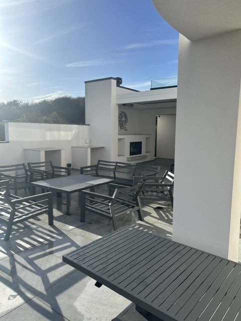 The wider terrace and outdoor kitchen, with bespoke Dekton tabletops.