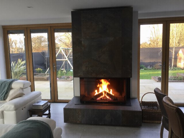 A built-in Spartherm Linear Triple wood burning stove in a bespoke porcelain feature wall in York
