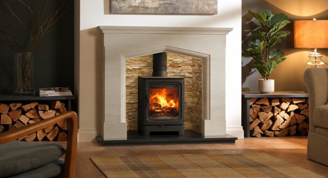 Staggered Oyster split face stove chamber within a Tudor arch natural limestone fireplace