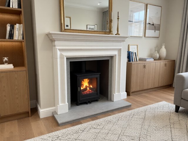 The Coxwold natural Scala limestone fireplace with a Dekton Soke Grey porcelain hearth and chamber