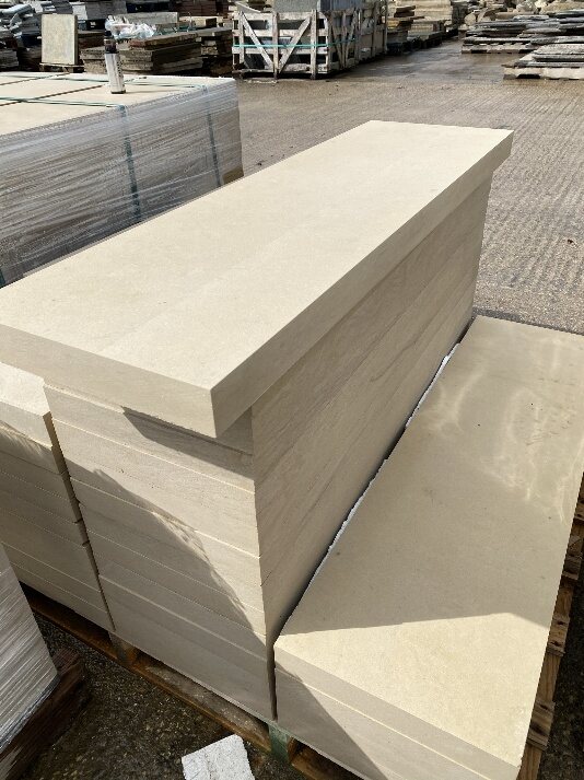 A stack of new sawn sandstone and gritstone slabs in the yard
