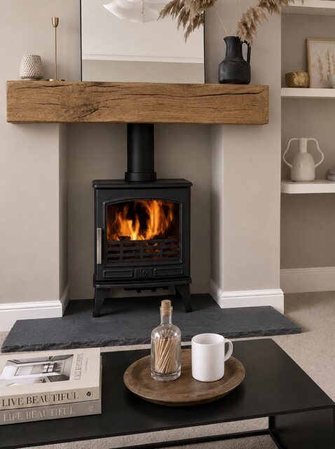 A wood burning stove on an Old Mill aged black limestone hearth