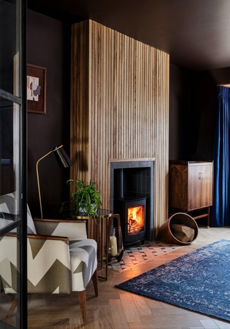 Slate chamber and border with a tiled hearth recessed into herringbone timber flooring in York