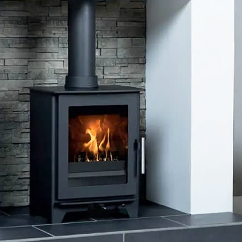 Heta Inspire 40 wood burning stove against a slate wall